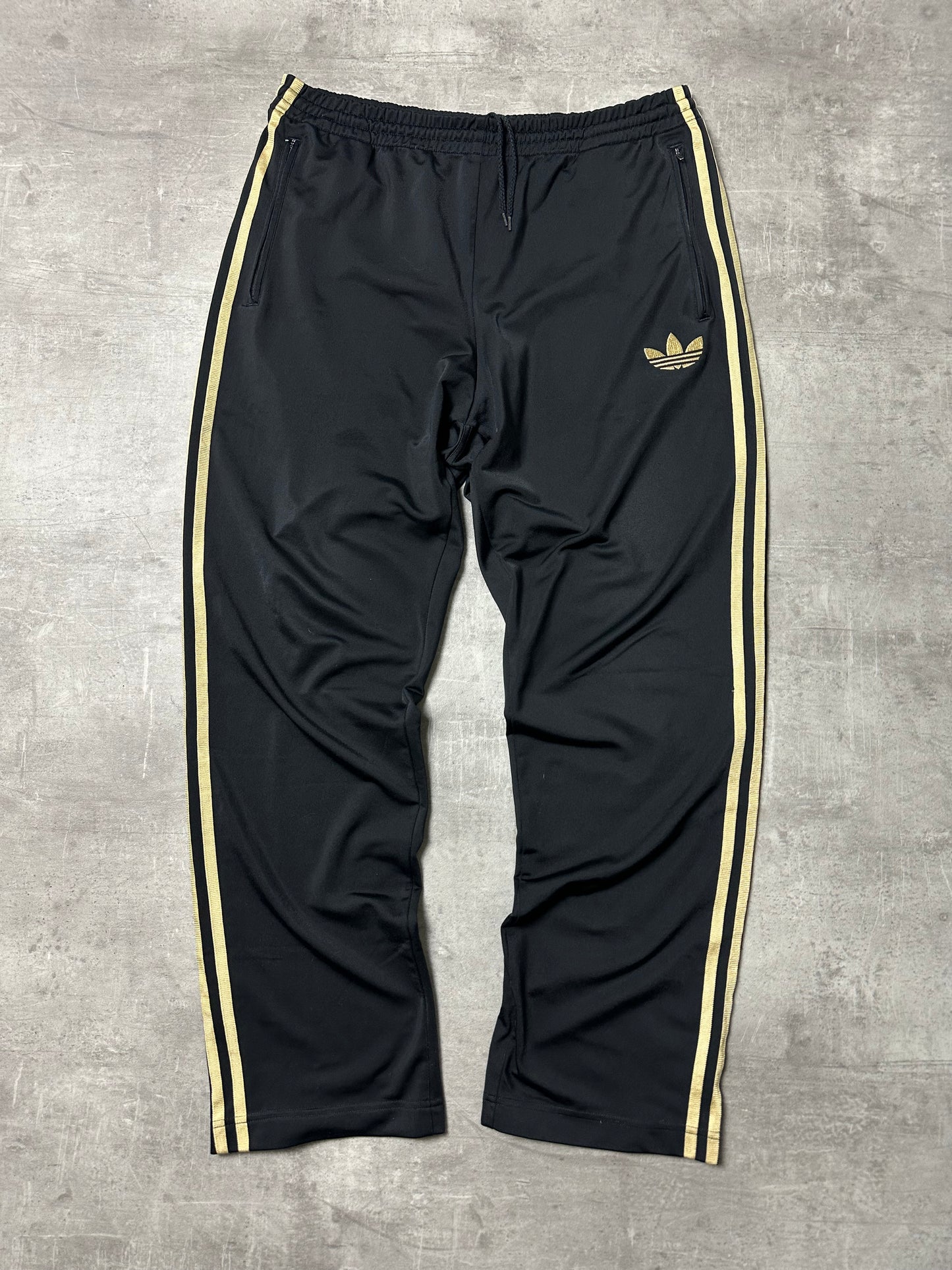 BLACK/GOLD VINTAGE ADIDAS FIREBIRD TRACKPANTS - 2000s - M