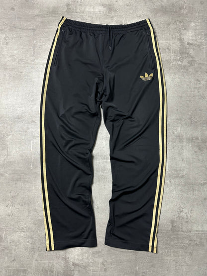 BLACK/GOLD VINTAGE ADIDAS FIREBIRD TRACKPANTS - 2000s - M