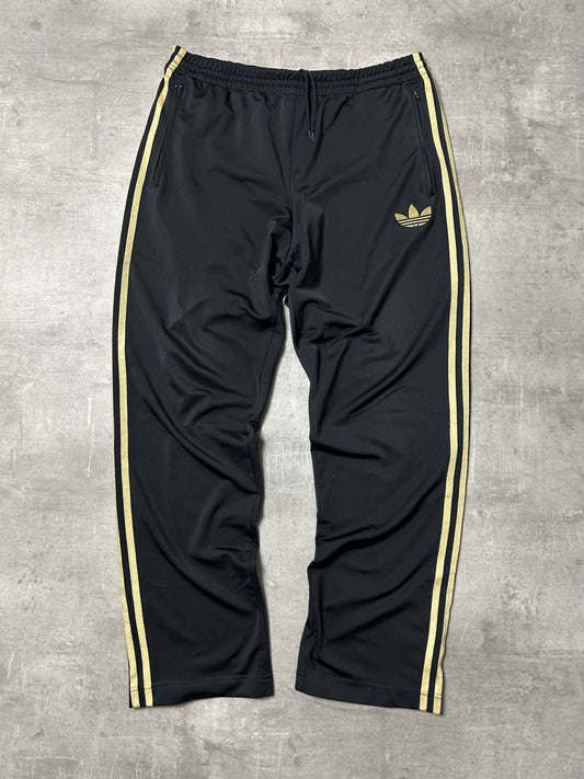 BLACK/GOLD VINTAGE ADIDAS FIREBIRD TRACKPANTS - 2000s - M